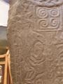 Side B Man w. spear and man w. knife - below cross left